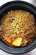 Bò kho served with instant noodles