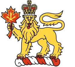 The crest of the King of Canada (and badge of the office of the Governor General of Canada), a crowned lion holding a maple leaf atop a torse.