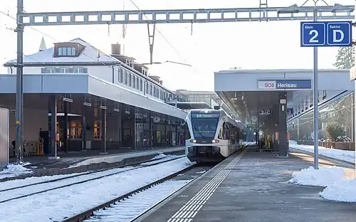 Train in snow with station platforms