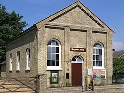 Large oblong brick building with metal railings