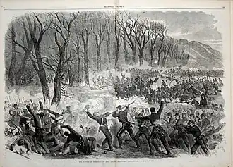 A black and white engraving of a battle. Troops assault from right to left into a line of trees, with mountains in the bank. In the center a shell explodes and a man is bayonetted.