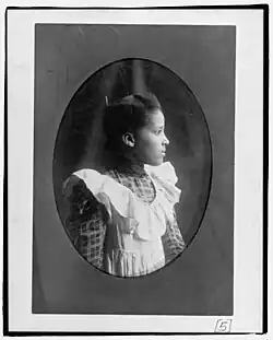 A young woman facing right