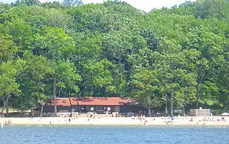 Building with beach on lake.