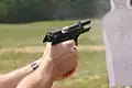 Beretta M9 semi-automatic pistol exhibiting muzzle rise just after firing a 9×19mm Parabellum cartridge.