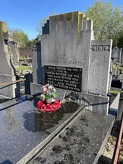 dark stone family monument in Arras communal ceremony, reflective dark stone with a plaque naming Rosine Witton, Bert Witton, Auguste Therier, and Leontine Becourt