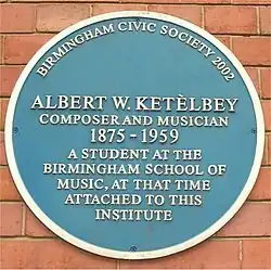 Plaque bearing the legend "Albert W Ketèlbey composer and musician 1875–1959 a student at the Birmingham school of music, at that time attached to this institute"