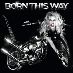 Grayscale image of a bike against a black background. The bike has Lady Gaga's head at its front, whose right hand stretches out to the front tires of the bike. The words "Born This Way" are embossed above the image.