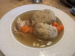 Bowl of matzah ball soup served on Passover