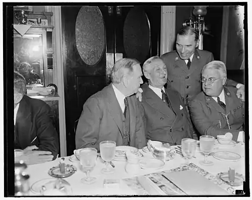 Former Boy Scouts get together. Washington, D.C., May 21. Boy Scouts of yesteryear, whose path led to the Nation's legislative halls, got together this morning for an old-fashioned breakfast of ham and eggs, the breakfast was held at the Senate restaurant, the occasion of the breakfast was a discussion of the Boy Scout Jamboree to be held in Washington, left to right: Sec. of Commerce Daniel Roper; Sen. William Gibbs McAdoo, D. of Calif.; James L. West, Pres. of the National Boy Scouts; and standing is Rep. Sol Bloom, New York[9]