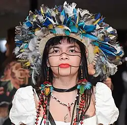 Front view of Suruí in headdress and white dress