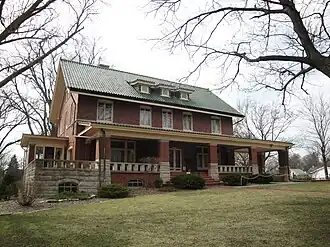 Photograph of Broadview Mansion, a two-and-a-half story, brick house with a broad veranda