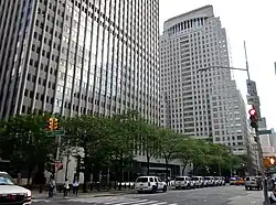 The exteriors of the Javits and Weiss federal buildings as seen from Broadway to the north. The Javits Building is on the left, in the foreground, and the Weiss Building is on the right, in the background.