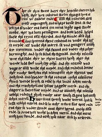 An old manuscript in thin blackletter font with some red ornamentation