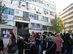 People mourning victims in front of the factory