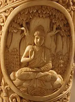 Buddha seated under a tree in Abhayamudra