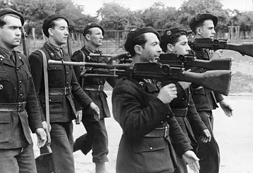 Black-and-white photo of men in uniform with guns