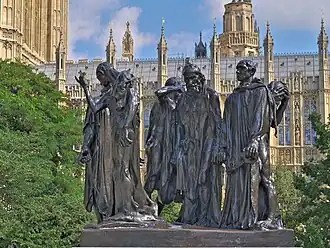 The London cast of The Burghers of Calais, with the Palace of Westminster in the background
