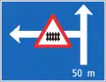 4.55 Announcement of a branching road with a dangerous situation or restrictions (here: side road to the left 50&nbsp;m ahead with the warning of the presence of a gated level crossing right after the turn)