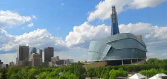 Downtown skyline alongside a building with a curved glass facade
