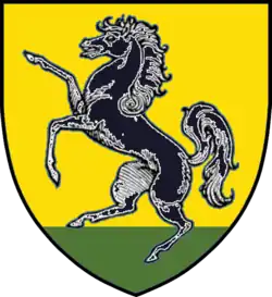 a prancing horse on a yellow background with green grass at the bottom