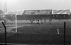 A black and white image of a football match.