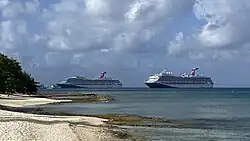 Carnival Liberty anchored in George Town, Grand Cayman with Carnival Sunrise on May 1, 2025