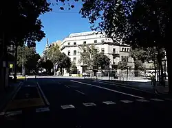The road Carrer Roger de llúria cureves to the left with some buildings visible