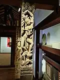 Carving of deity on wooden pillar