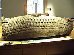Photograph of a hogback sculpted tombstone