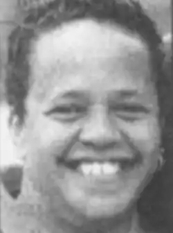 A smiling African-American woman with short curls