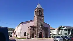 A pink cathedral with a bell tower at the centre