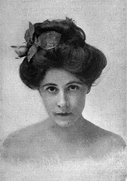 A young white woman with dark hair in a bouffant updo