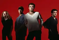 Band members in a dark red background