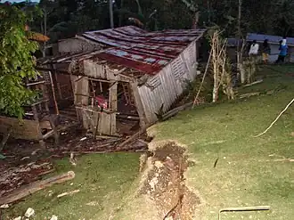 Destroyed home in Catigbian and ground rupture