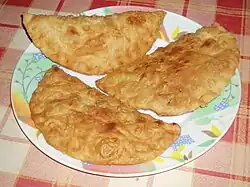 Three big fried dumplings (chebureki) on a plate