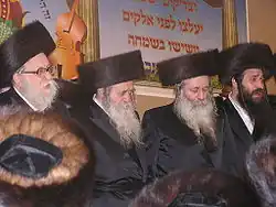 Four rabbis wearing distinctive, round fur hats
