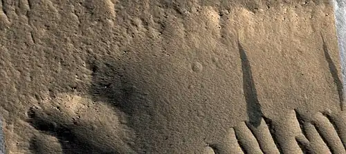 Close view of dark slope streaks on wall of trough as seen by HiRISE under HiWish program. The image is about 1&nbsp;km across.