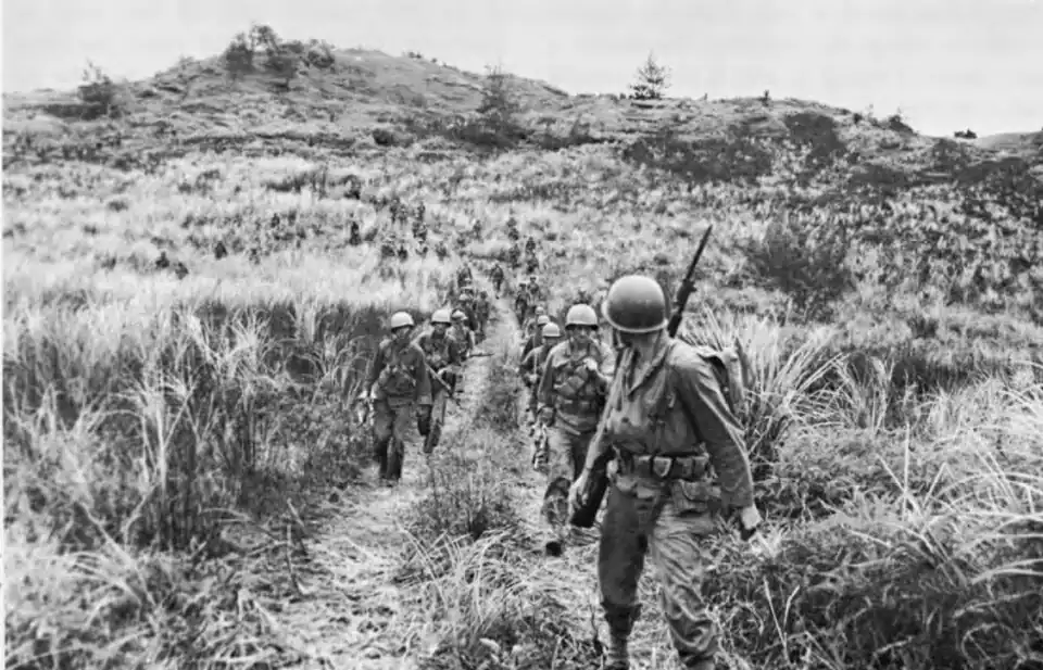 Company B, 305th Infantry, moving out from the high ground