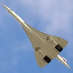 A view from below of an aeroplane in flight, with a slender fuselage and swept back wings.