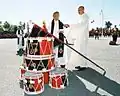 During a military-religious flag Consecration ceremony, Canadian Forces chaplains bless the Royal Military College of Canada Colours, which lean on top of a stack of College drums on a platform
