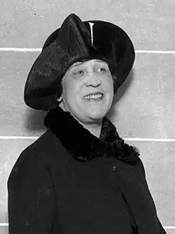 Head-and-shoulders photo of a Balfour facing slightly right, wearing a dark coat with fur trim, and a hat