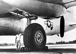The single main tire of an XB-36 is about 1.5 times taller than the person standing beside it.