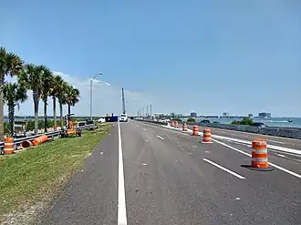 Highway diverted from former alignment to pass around construction site with crane