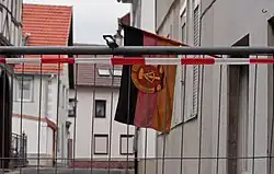 A GDR flag hanging on a building