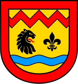 A coat of arms depicting the head of a black animal with an open mouth showing to a black lily shaped symbol. In the bottom half is a blue horizontal stripe and in the top a red horizontal zigzag. The background is yellow and it has a red frame.