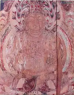 Frontal view of a cross-legged seated deity.