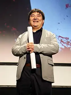 An Asian man in a suit