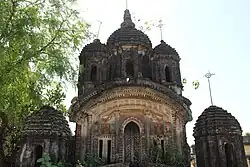 Badanganj: Damodara temple (in picture), built in 1810, with terracotta façade, and Sridhar Laljiu temple, built in 1802, with terracotta designs.