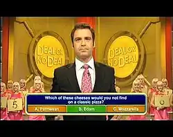 Andrew O'Keefe looks past the camera as a lower third graphic shows a correct answer to a question