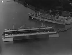 Aerial view of dry dock Dewey with USS Jason (AV-2) nearby, October 1928